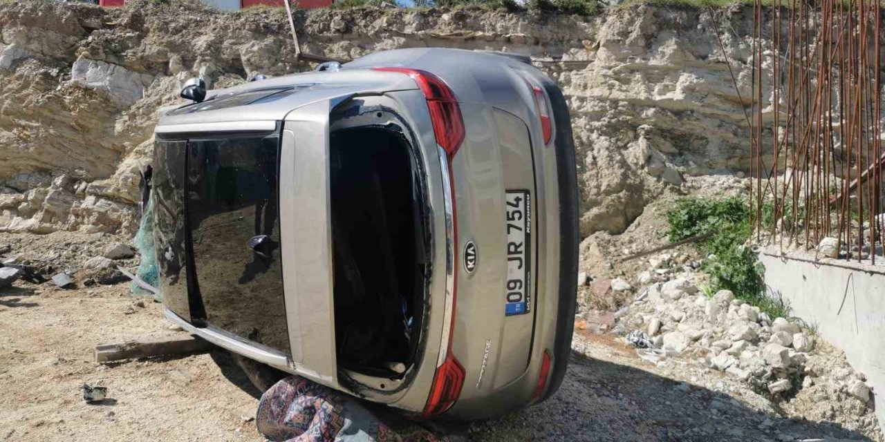 Yoldan çıkan lüks araç inşaat alanına devrildi