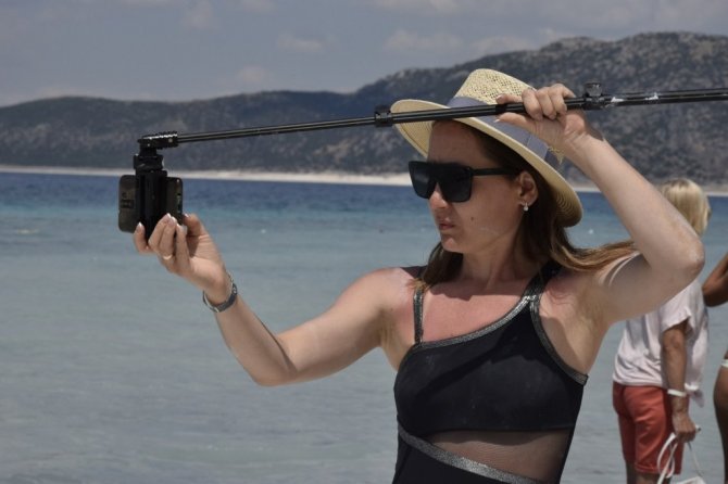 Suyu çekilen Salda gölü kıyısına yakın adaya yürüyerek geçiyorlar